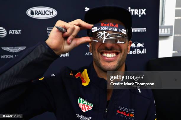 Daniel Ricciardo of Australia and Red Bull Racing signs autographs during the Red Bull Racing Drivers Factory Visit at Red Bull Racing Factory on...