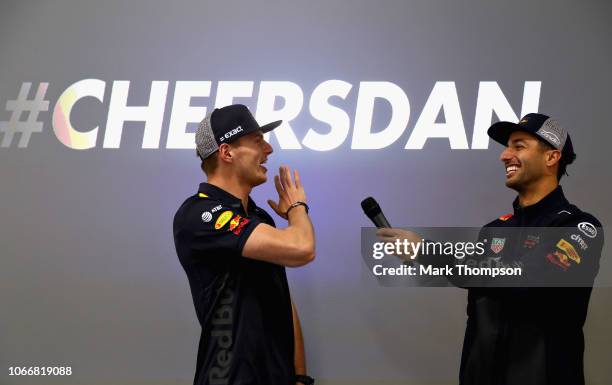 Max Verstappen of Netherlands and Red Bull Racing and Daniel Ricciardo of Australia and Red Bull Racing talk to the Red Bull Racing team during the...