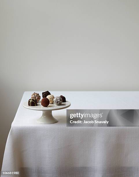 confections displayed on white linen table. - tischtuch stock-fotos und bilder