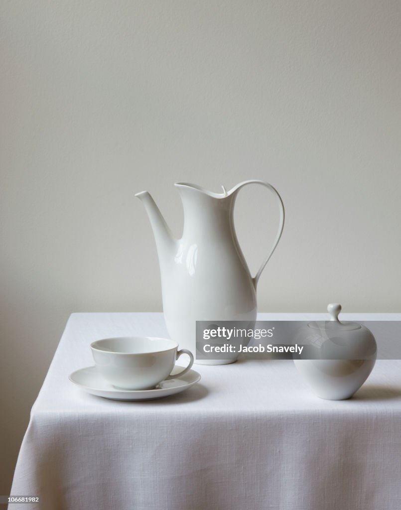 Classic tea/coffee set on white linen table.