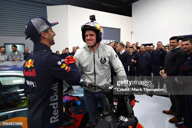 Daniel Ricciardo of Australia and Red Bull Racing shakes hands with Dougie Lampkin during the Red Bull Racing Drivers Factory Visit at Red Bull...