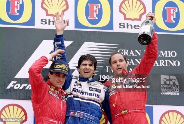 Williams driver Damon Hill of Great Britain celebrates after winning the San Marino Grand Prix with 2nd placed Jean Alesi of France & Ferrari and 3rd...