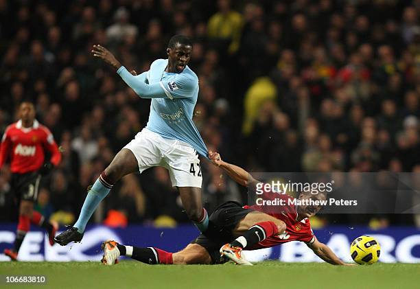 Nemanja Vidic of Manchester United clashes with Yaya Toure of Manchester City during the Barclays Premier League match between Manchester City and...