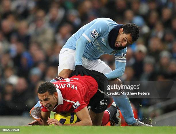 Rio Ferdinand of Manchester United clashes with Carlos Tevez of Manchester City during the Barclays Premier League match between Manchester City and...