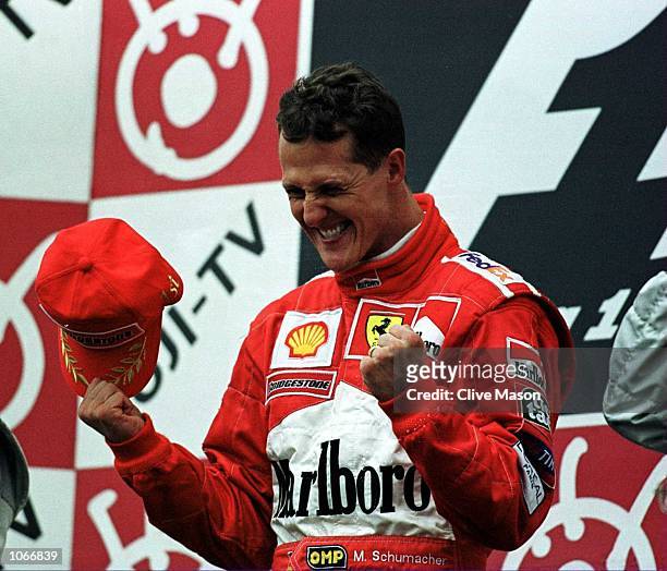 Michael Schumacher of Germany and Ferrari celebrates after winning the formula one world championship at the Japanese Grand Prix at Suzuka, Japan....