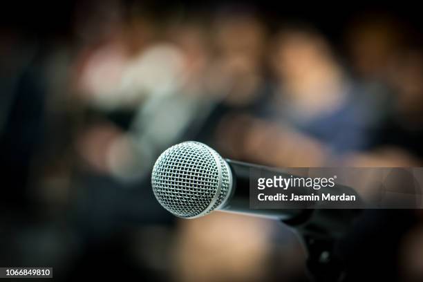 microphone in front of audience - press conference stock pictures, royalty-free photos & images