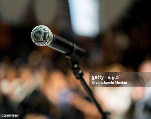 microphone in front of audience - press conference stock pictures, royalty-free photos & images