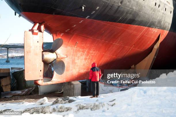one people in front of a ship at shipyard of stokmarknes, norway - ship propeller stock pictures, royalty-free photos & images