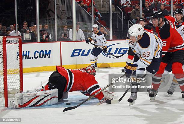 Tyler Ennis of the Buffalo Sabres is stopped by Johan Hedberg of the New Jersey Devils at the Prudential Center on November 10, 2010 in Newark, New...