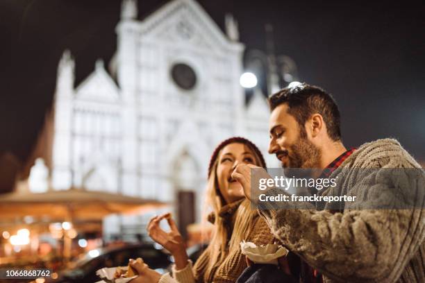 eating street food at the christmas markets in italy - florence italy stock pictures, royalty-free photos & images