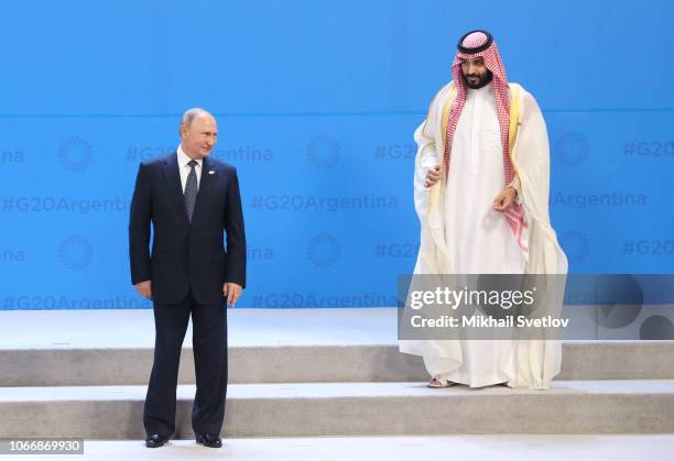 Russian President Vladimir Putin and Saudi Arabia's Crown Prince Mohammad bin Salman Al Saud attend the G20 Summit's Plenary Meeting on November 30,...