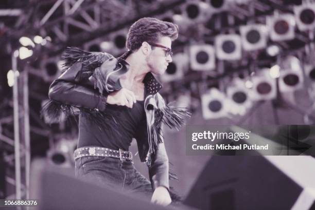 English singer-songwriter George Michael of pop duo Wham! performs live on stage at the group's farewell concert, entitled 'The Final', at Wembley...