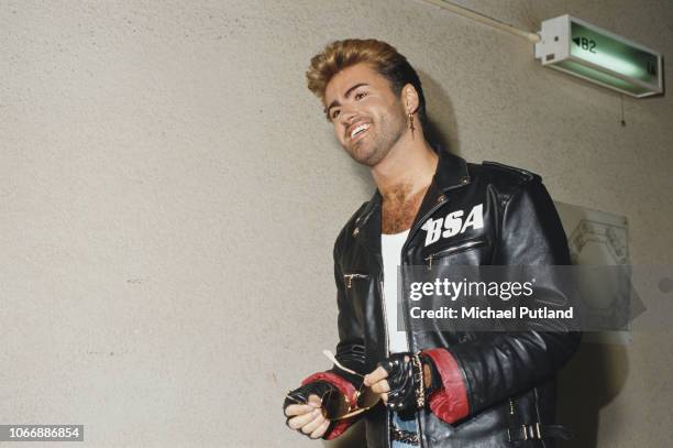 English singer and songwriter George Michael pictured wearing a leather jacket with BSA logo backstage during the Japanese/Australasian leg of his...