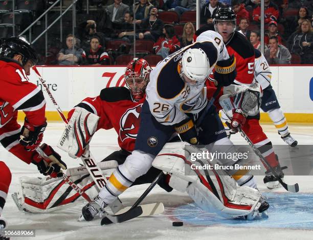 Thomas Vanek of the Buffalo Sabres attempts to get the puck past Johan Hedberg of the New Jersey Devils at the Prudential Center on November 10, 2010...