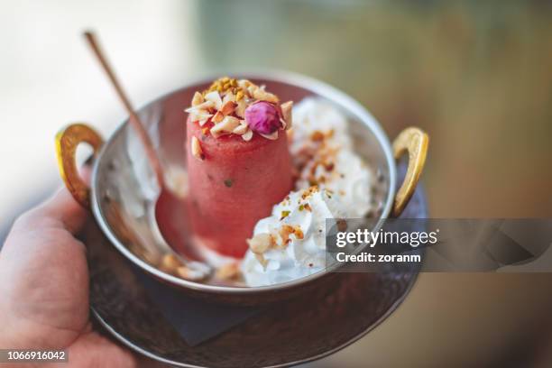 kulfi serving in hand - panna cotta stock pictures, royalty-free photos & images