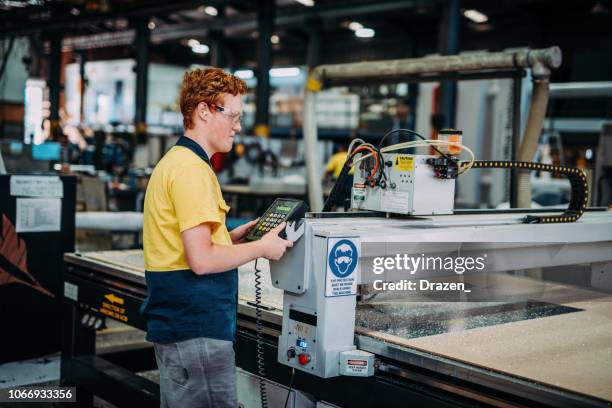 young engineer checking the cnc machine process - making stock pictures, royalty-free photos & images