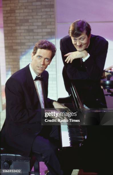 Comic actors Hugh Laurie and Stephen Fry sitting at a piano in a sketch from the BBC television series 'A Bit of Fry and Laurie', March 22nd 1994.