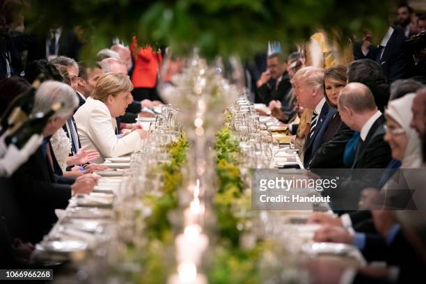 German Chancellor Angela Merkel talks to US President Donald Trump during the dinner for the participants and partners of the G20 Summit at the Colon...