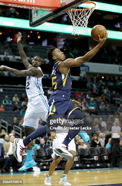 Donovan Mitchell of the Utah Jazz drives to the basket against Marvin Williams of the Charlotte Hornets during their game at Spectrum Center on...