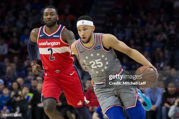 Ben Simmons of the Philadelphia 76ers dribbles the ball against John Wall of the Washington Wizards in the first quarter at the Wells Fargo Center on...