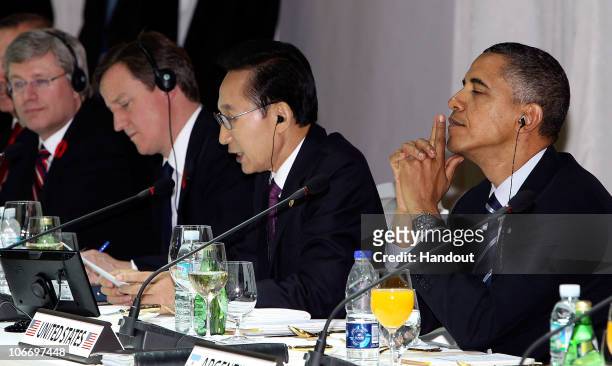 In this handout image provided by Yonhap News, U.S. President Barack Obama listens as South Korean President Lee Myung-bak makes a welcome speech...