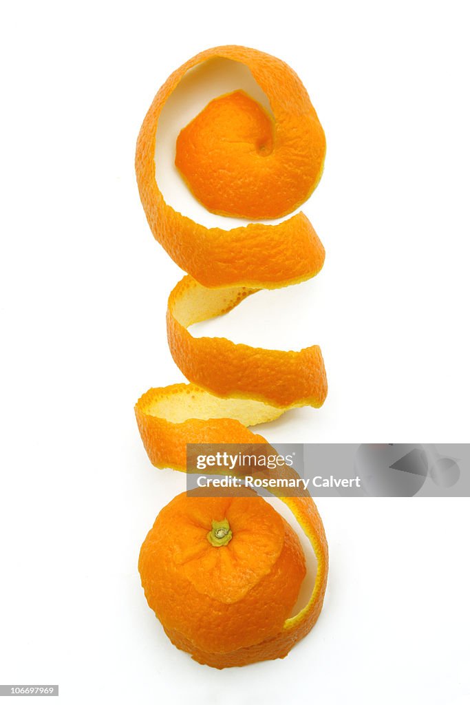 Orange peel removed to form coil,white background