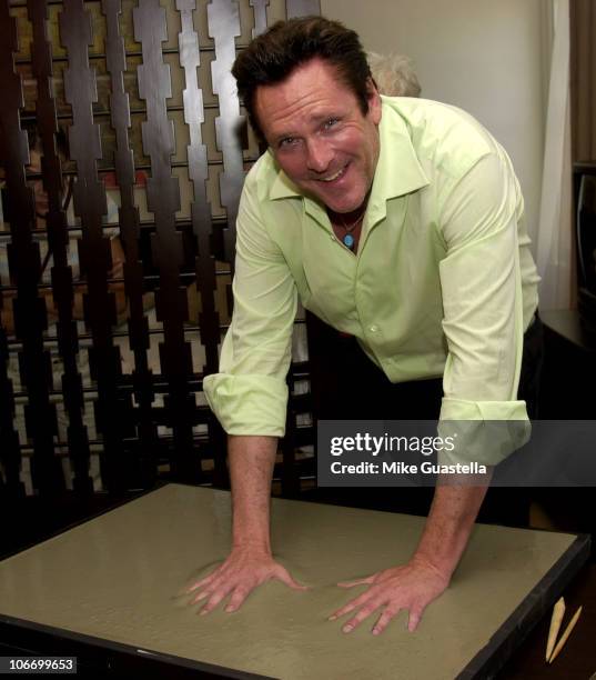 Michael Madsen placing his handprint and bootprint in cement to be displayed with other celebrity cement impressions in the rooms at the Roosevelt...
