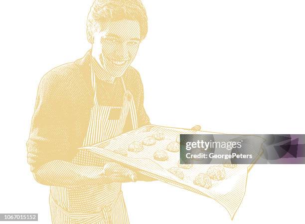 young man baking cookies - baking sheet stock illustrations