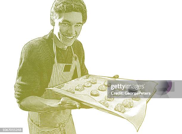 young man baking cookies - baking sheet stock illustrations