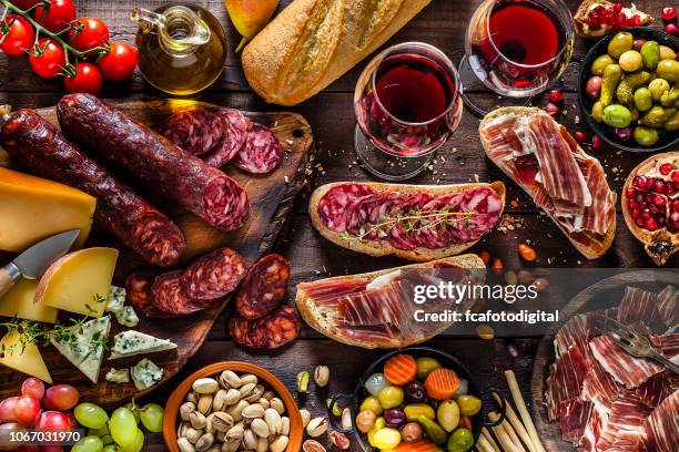 deliscious appetizer on rustic wood table - wine glass from above stock pictures, royalty-free photos & images