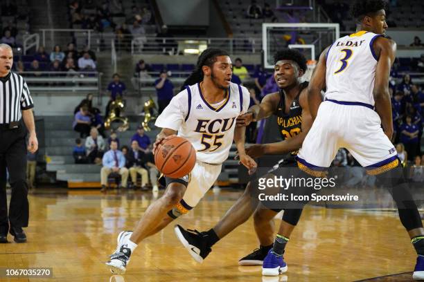 East Carolina Pirates guard Shawn Williams dribbles around a screen by East Carolina Pirates forward Seth LeDay during a game between the East...