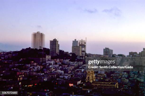 Aerial view of San Francisco, California at dusk, including Saints Peter and Paul church and buildings under construction, color image on Kodachrome...