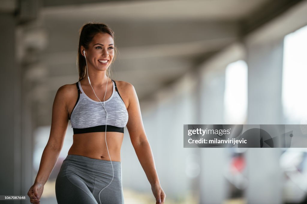 Smiling woman resting after workout