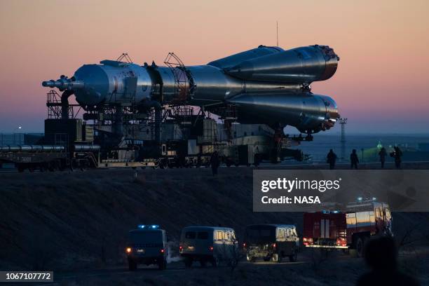 In this handout provided by NASA, T The Soyuz booster rocket and MS-11 spacecraft are rolled out to the launch pad by train at the Baikonur...