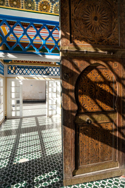 corridor with traditional zellij tiling and old carved wooden door, bahia palace (19th century), medina of marrakesh, unesco world heritage site, morocco - palais de la bahia photos et images de collection