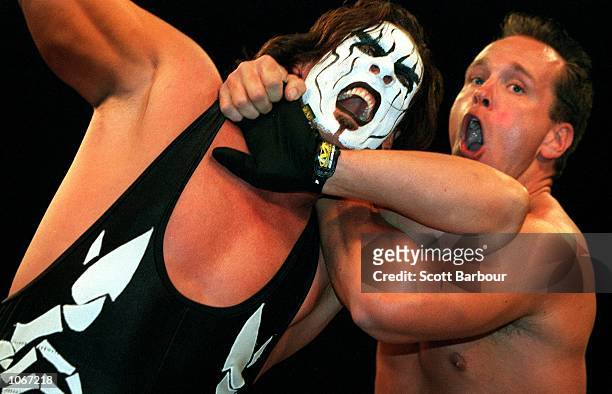 Sting is held by Mike Sanders during their bout at the World Chamionship Wrestling ''Thunder Down Under'' night at the Sydney Entertainment Centre,...