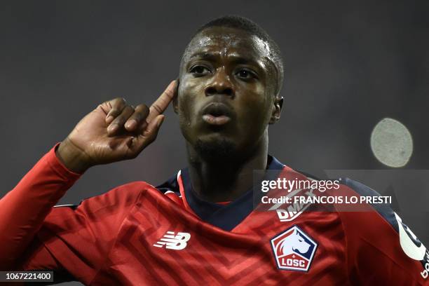 Lille's Ivorian forward Nicolas Pepe celebrates after scoring a goal during the French L1 football match between Lille and Olympique Lyonnais on...