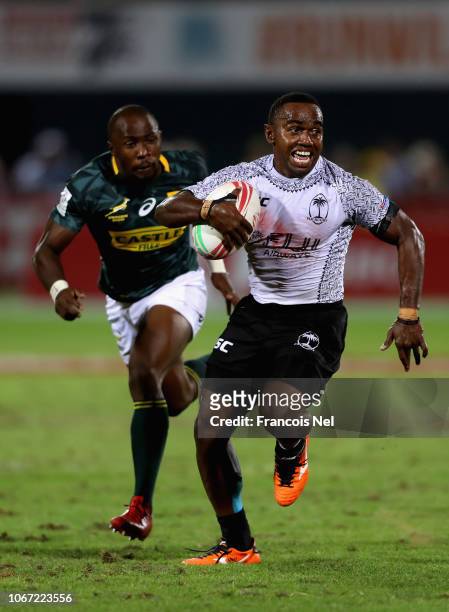 Jerry Tuwai of Fiji avoids a tackle from Siviwe Soyizwapi of South Africa during the 5th Place Play-Off match between South Africa and Fiji on Day...