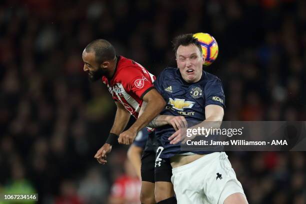 Nathan Redmond of Southampton and Phil Jones of Manchester United go up for a header during the Premier League match between Southampton FC and...