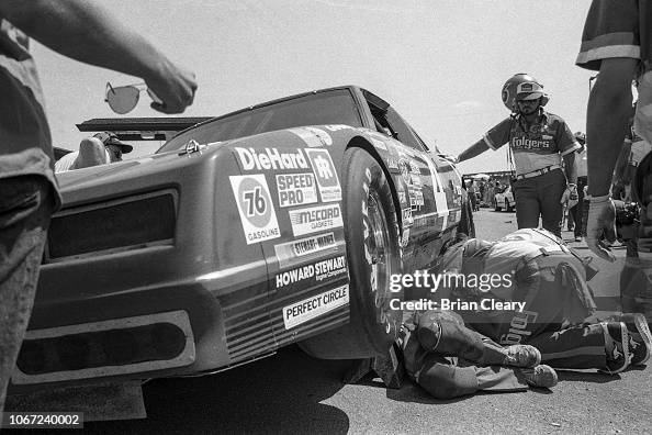 Crewmen work to repair the Chevrolet of Joe Ruttman during the... News ...