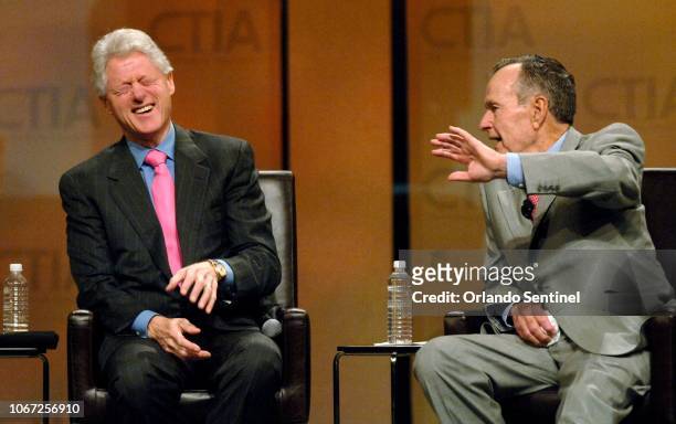 Former president George H.W. Bush makes a joke with former president Bill Clinton at the CTIA Wireless 2007 convention at the Orange County...