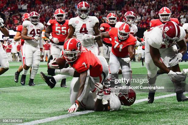 Andre Swift of the Georgia Bulldogs rushes for a 9-yard touchdown in the second quarter against the Alabama Crimson Tide during the 2018 SEC...