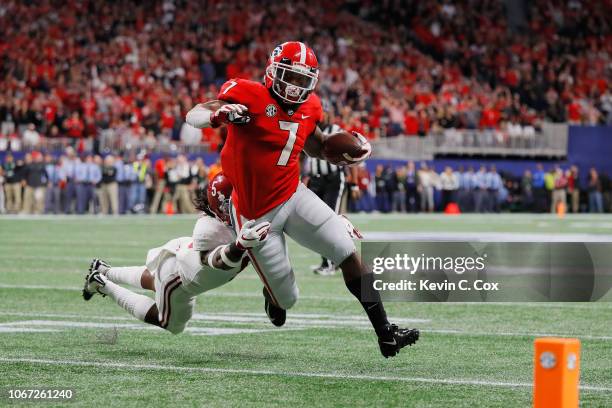 Andre Swift of the Georgia Bulldogs scores an 11-yard receiving touchdown in the second quarter as Shyheim Carter of the Alabama Crimson Tide is...