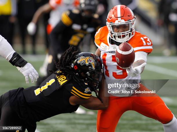 Don Unamba of the Hamilton Tiger-Cats defends a pass to Tyrell Sutton of the BC Lions during the Eastern Semi-Final game at Tim Hortons Field on...