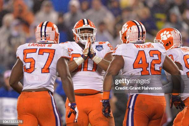Dexter Lawrence and teammates Tre Lamar and Christian Wilkins of the Clemson Tigers react against the Pittsburgh Panthers in the first quarter during...