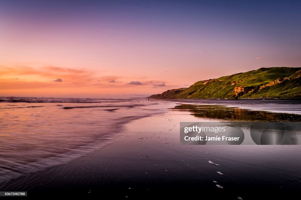 Sunset over Karioitahi beach black sand Waiuku