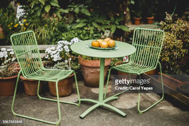 green garden furniture in a small garden. - wooden bench stock pictures, royalty-free photos & images