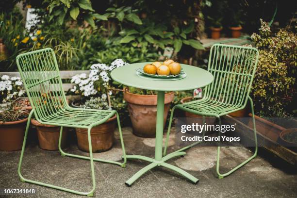 green garden furniture in a small garden. - back garden stock pictures, royalty-free photos & images