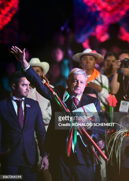 Mexico's new President Andres Manuel Lopez Obrador waves during a ceremony in which he received a ceremonial staff from indigenous people, at the...