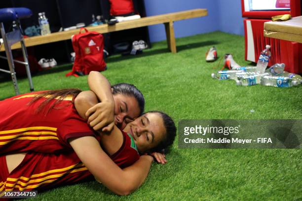 Ana Tejada of Spain and Maria Mendez of Spain hug in the locker room after winning the FIFA U-17 Women's World Cup Uruguay 2018 final match between...